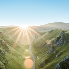 Sunlight over green mountain landscape